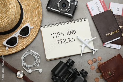 Flat lay composition with notebook on grey table. Tips and Tricks photo