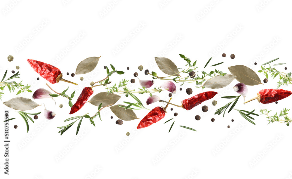 Fototapeta premium Many different spices flying on white background