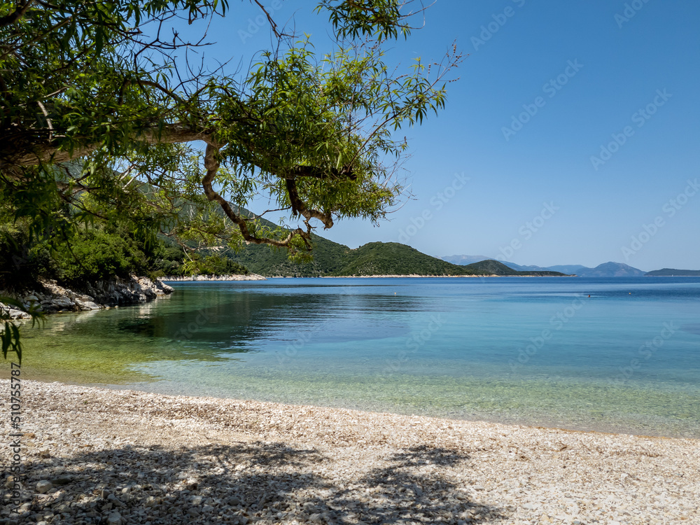 A pristine beach with crystal clear calm water on Ithaca Island, Greece.