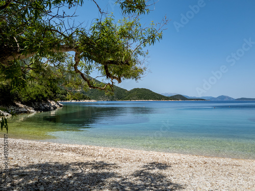 A pristine beach with crystal clear calm water on Ithaca Island, Greece.