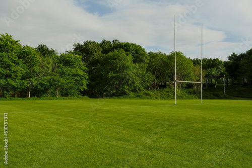 Green field with tall goal post for Irish National sport hurling and camogie in a park. Popular activity in Ireland for man, woman and children. photo