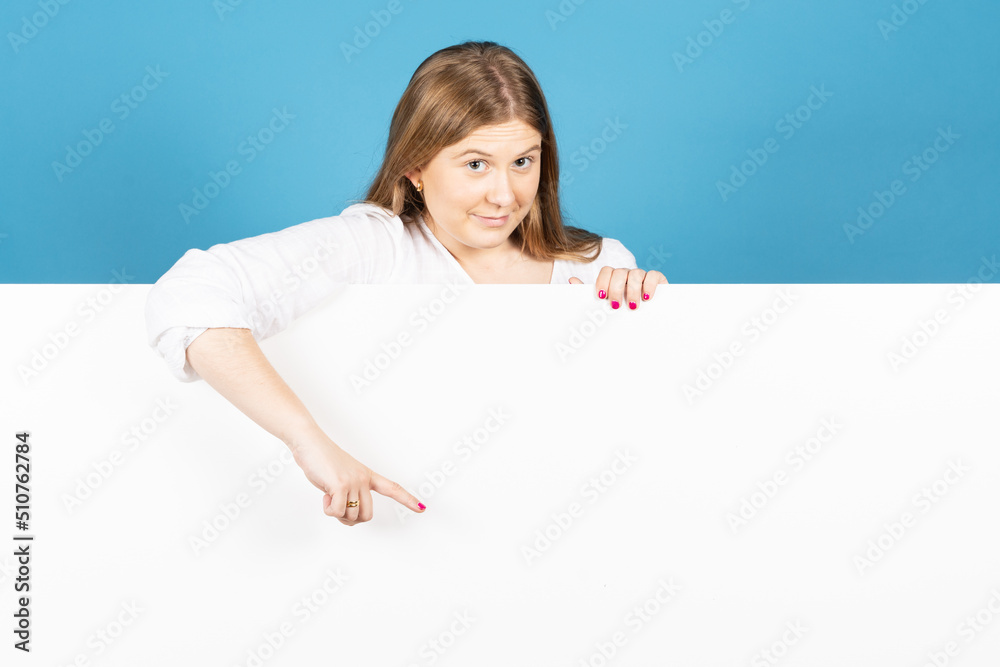 Young pretty woman pointing at whiteboard. Showing white copy space. Young pretty woman pointing at whiteboard. Showing white copy space.