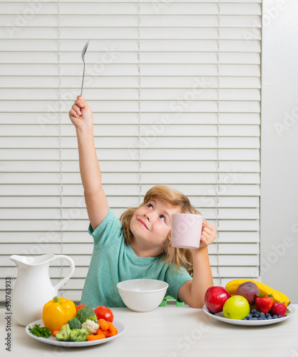 Little child boy having healthy breakfast. Kids nutrition and development. Eating vegetables by child make them healthier.