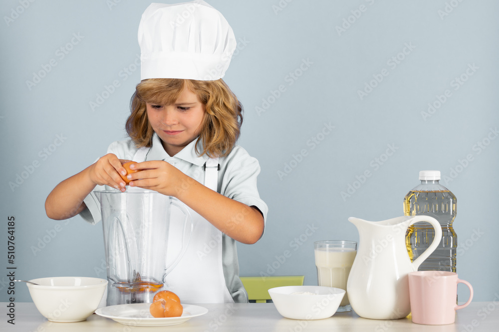 Portrait of chef child in cook hat. Cooking at home, kid boy preparing food from vegetable and fruits. Healthy eating. Portrait of chef child in cook hat. Cooking at home, kid boy preparing food from vegetable and fruits. Healthy eating.