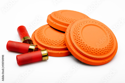 Red shotgun shell and clay pigeon target on white background , Gun shooting game