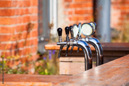 Beer taps are on bar counter, outdoor