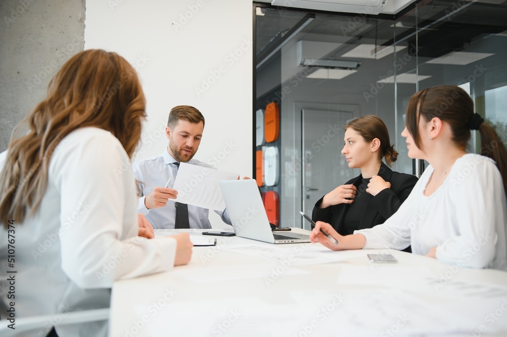 Corporate business team and manager in a meeting room at modern office with panoramic windows. Business concept Corporate business team and manager in a meeting room at modern office with panoramic windows. Business concept