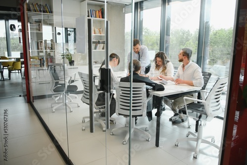 Corporate business team and manager in a meeting room at modern office with panoramic windows. Business concept