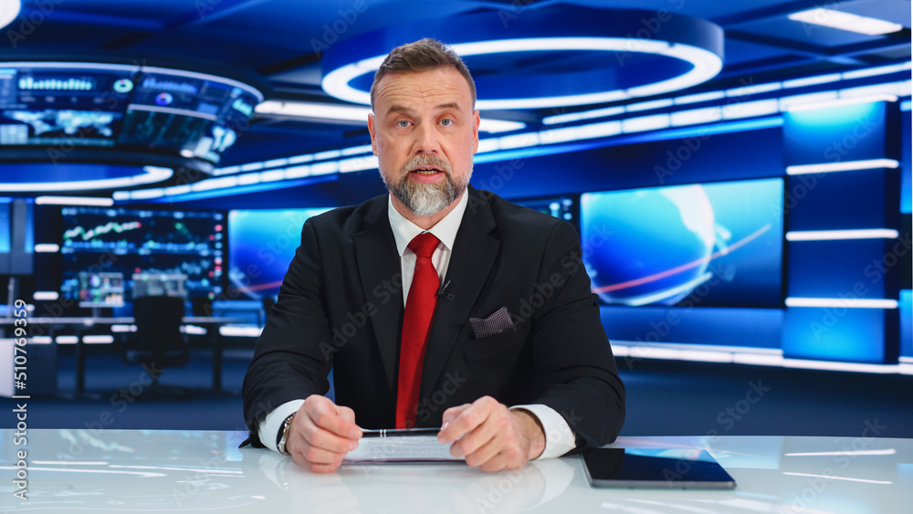 TV Live News Program: Charismatic White Male Presenter Reporting. Television Cable Channel Anchorman or Host Talking about Important Events. Network Broadcast Mock-up. Modern Newsroom Studio TV Live News Program: Charismatic White Male Presenter Reporting. Television Cable Channel Anchorman or Host Talking about Important Events. Network Broadcast Mock-up. Modern Newsroom Studio