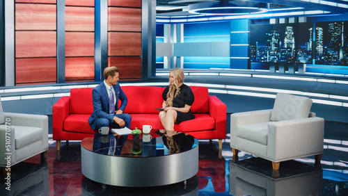 Foto Talk Show TV Program and News Discussion: Two Cheerful Presenters Talk, Have Fun