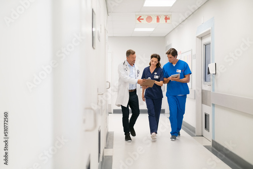 Medical staff discussing report at hospital photo