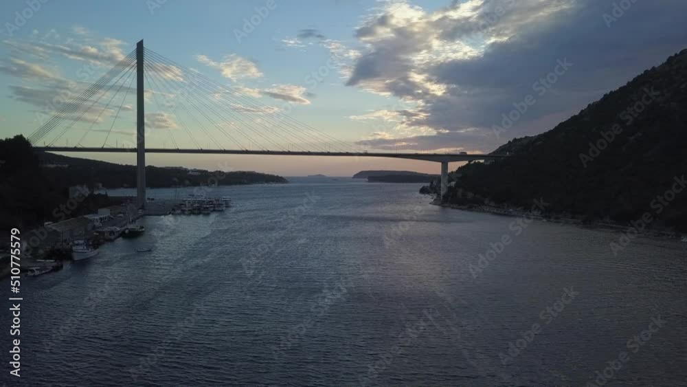 Silhouette of tall bridge over windy Dubrovnik inner harbour at dusk Silhouette of tall bridge over windy Dubrovnik inner harbour at dusk