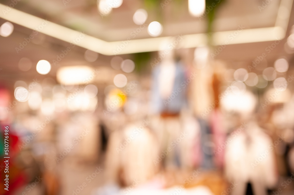 Blurred view of modern boutique interior with stylish clothes
