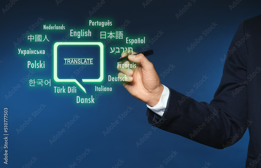 Translator pointing at virtual screen with names of different languages on blue background, closeup Translator pointing at virtual screen with names of different languages on blue background, closeup