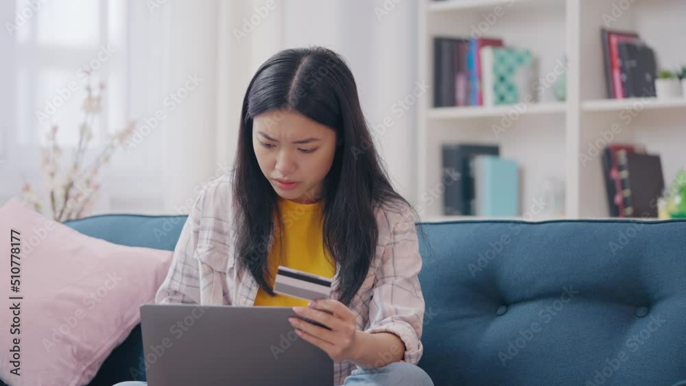 Asian female falling victim to online scam, credit card phishing, identity theft Asian female falling victim to online scam, credit card phishing, identity theft
