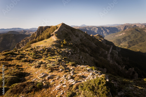 Rugged dry mountain ridge with jeep trail in rugged landscape 
