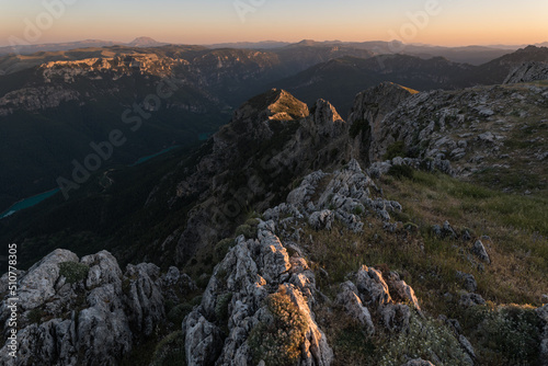 Jagged mountain edge and valley below at golden hour