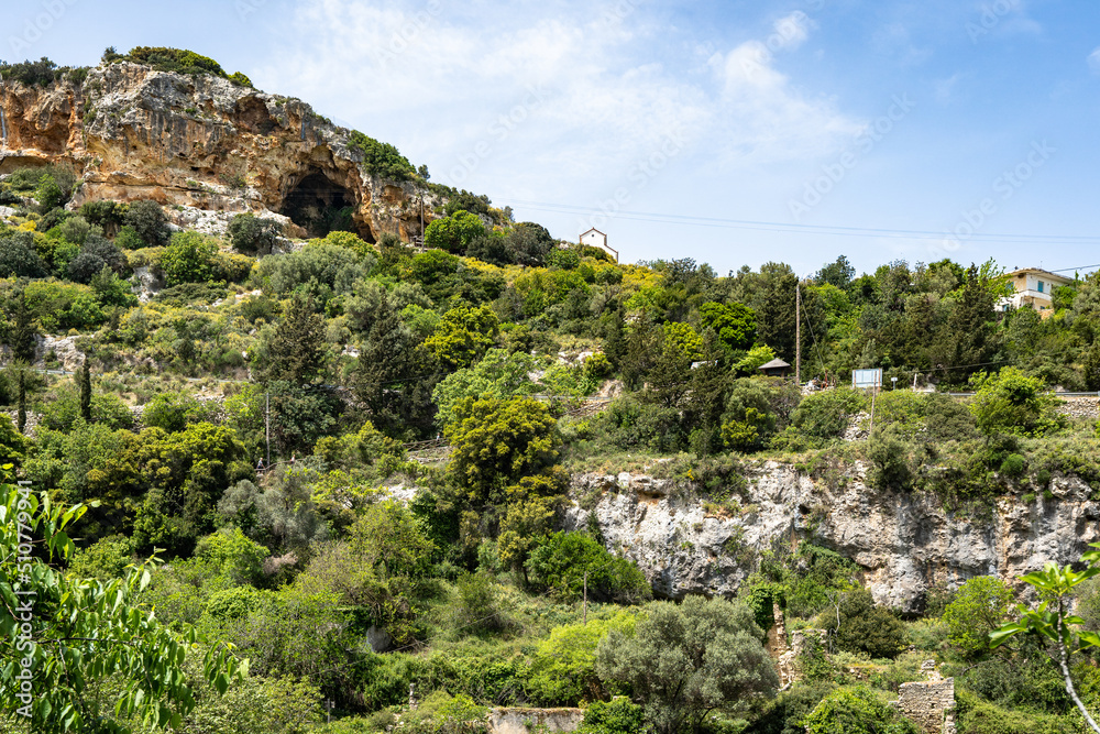 Beautiful mountain, cliff, limestone rock covered with forest. Mediterranean landscape. A cave inside the mountain at the top. Greece, Rethymnon area. Beautiful mountain, cliff, limestone rock covered with forest. Mediterranean landscape. A cave inside the mountain at the top. Greece, Rethymnon area.