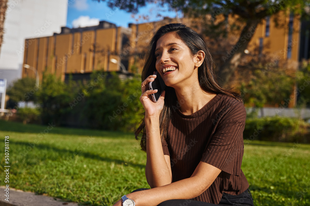 Laughing young businesswoman talking by phone Laughing young businesswoman talking by phone