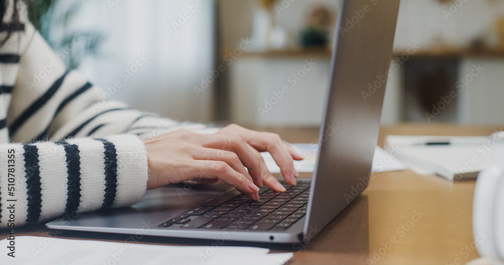 Freelance Asia lady casual wear using laptop online in kitchen at home office. Working from house, remotely work, distance education, social distancing, quarantine for coronavirus. Close up shot. Freelance Asia lady casual wear using laptop online in kitchen at home office. Working from house, remotely work, distance education, social distancing, quarantine for coronavirus. Close up shot.