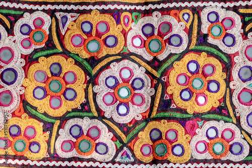 Mirrored embroidery work typical of the Aahir tribe,unidentified man embroidering cloth in traditional method of India,mirror work colorful handmade ahir bharat,Kutch-gujarat
