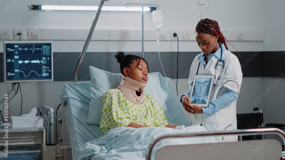 Physician explaining radiography to patient with neck collar in ...
