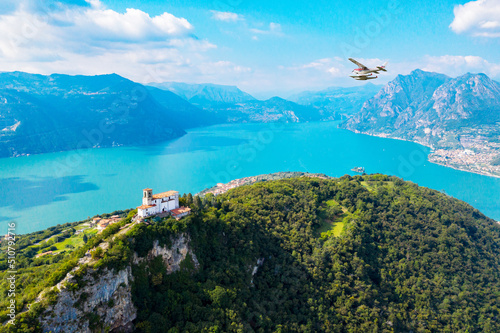 Fotografía Aerial view of Madonna della Ceriola church in Monte Isola, with seaplane at lak