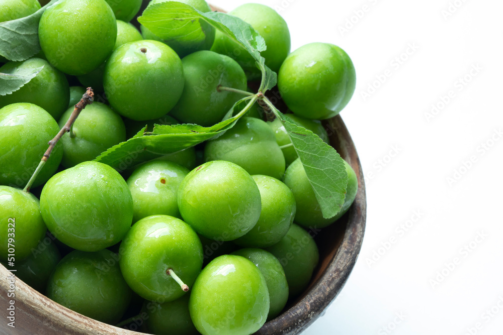 a bowl green plum over white background a bowl green plum over white background