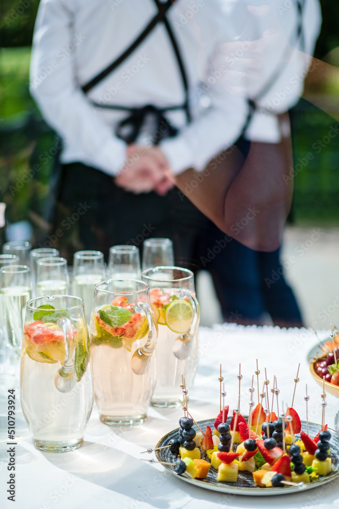 waitress catering service. female staff servicing dish full of snack food at restaurant event waitress catering service. female staff servicing dish full of snack food at restaurant event