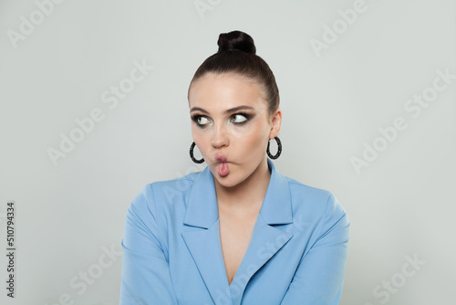 Young beautiful woman making fish face with lips, crazy and comical gesture. Funny facial expression.