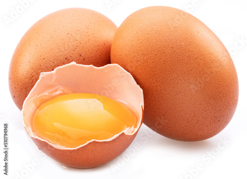 Brown chicken eggs and egg yolk isolated on white background. photo
