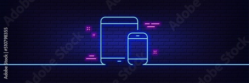 Neon light glow effect. Mobile Devices icon. Smartphone and Tablet PC signs. Touchscreen gadget symbols. 3d line neon glow icon. Brick wall banner. Mobile devices outline. Vector