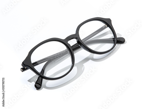 Black glasses for reading folded on white background. Plastic eyeglasses business and office style in minimal concept for promo banner sale and shopping