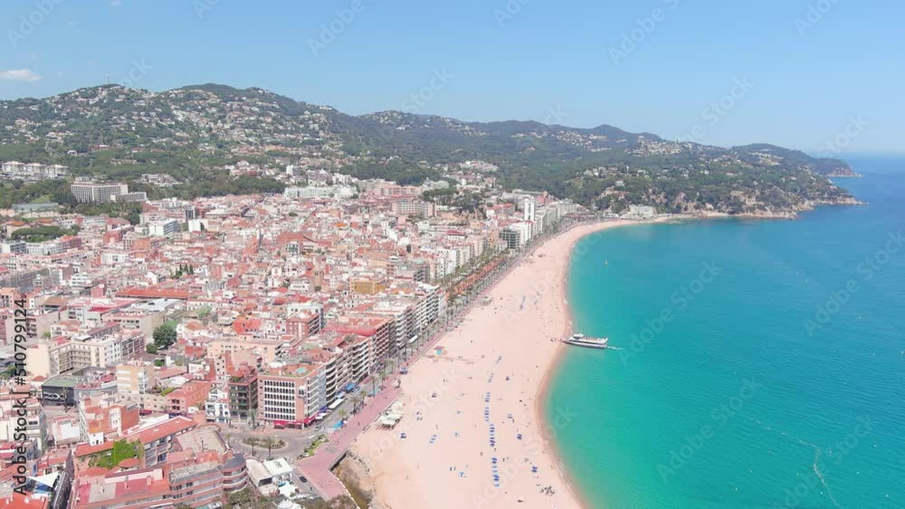 Lloret de Mar, Spain: Aerial view of resort town on Costa Brava near Barcelona, Lloret Beach (Platja de Lloret de Mar), clear waters of Mediterranean Sea - landscape panorama of Europe from above Lloret de Mar, Spain: Aerial view of resort town on Costa Brava near Barcelona, Lloret Beach (Platja de Lloret de Mar), clear waters of Mediterranean Sea - landscape panorama of Europe from above