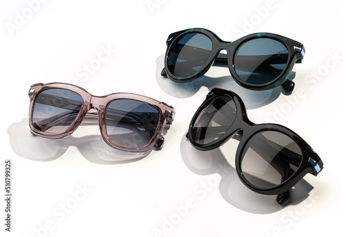 Set of Stylish sunglasses with bright sunlight on white background. Front, top view. Summer sunglass fashion concept. Trendy women glasses