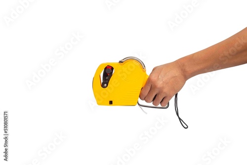 Hand holding yellow shop pricing gun isolated on a white background