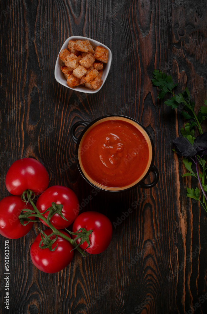 Tomato soup on wooden table, top view Tomato soup on wooden table, top view