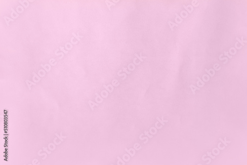 Pale sweet candy plain pink color on recyclable creased blank paper texture background with space