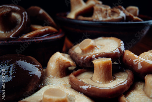 A scattering of delicious pickled mushrooms . Salted mushrooms .