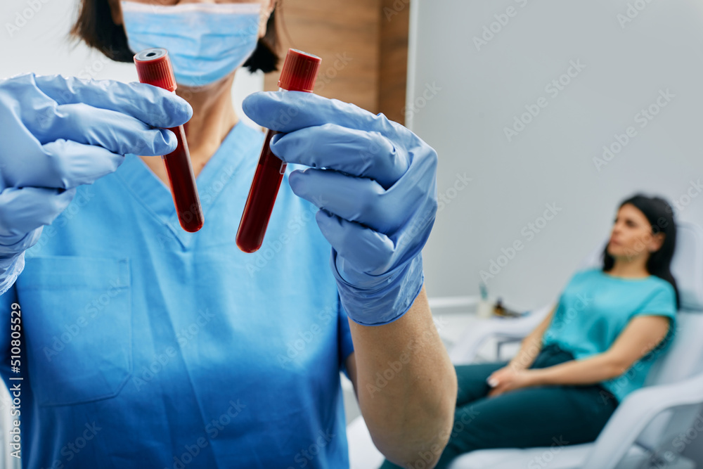 Nurse taking blood for allergen testing by collecting blood in test