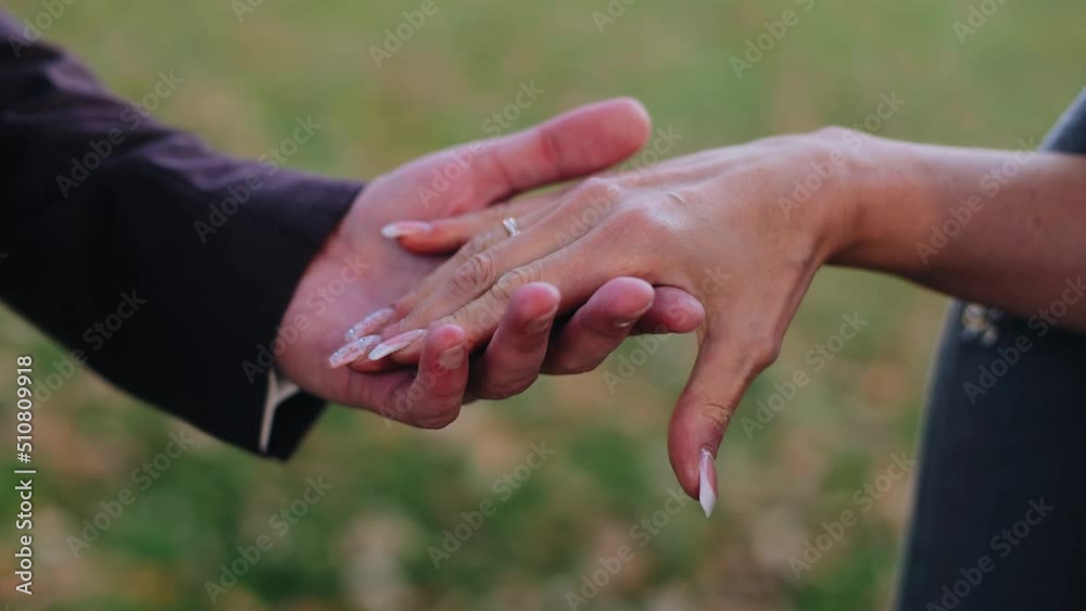 The guy gently takes his lover's hand in his palm Close-up in slow motion The guy gently takes his lover's hand in his palm Close-up in slow motion