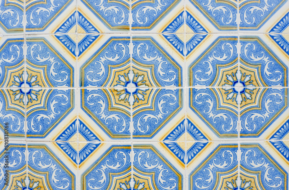 Traditional vintage tiles on the wall outside in downtown district in Porto, Portugal