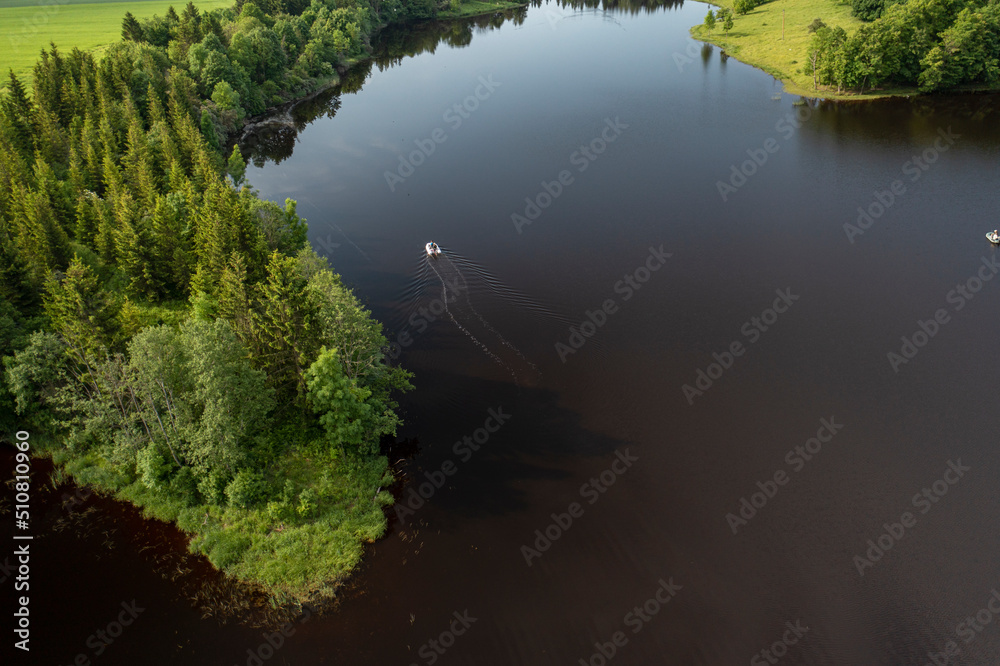 Aerial photo: camera follows a boat in the lake Aerial photo: camera follows a boat in the lake