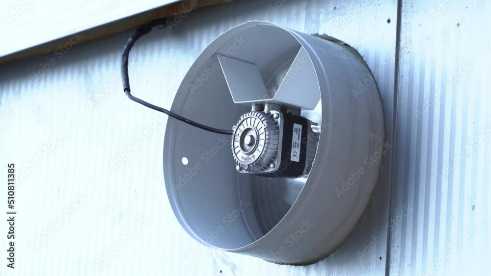 closeup grey metal industrial fan which is attached to the building which needs to be cooled