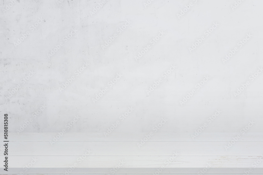Clean white wooden desk with white wall in background for product presentation Clean white wooden desk with white wall in background for product presentation