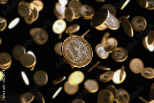 Many euro coins falling on an isolated black background. 3d render
