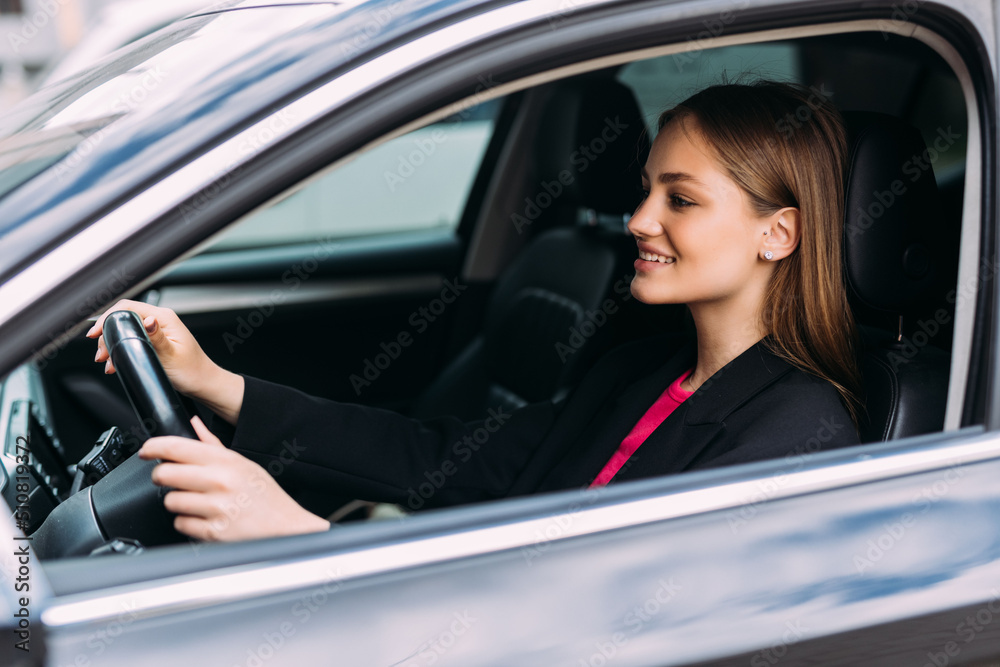 Happy smiling young woman or female driver driving car and drinking takeaway coffee Happy smiling young woman or female driver driving car and drinking takeaway coffee