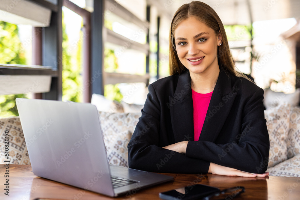 Young business woman using laptop in a cafe Young business woman using laptop in a cafe