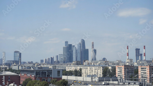 Panoramic view of city and blue skyscrapers. Action. Simple view of city on background of high-rise buildings in Moscow city. Skyscrapers of Moscow city on horizon on background blue sky