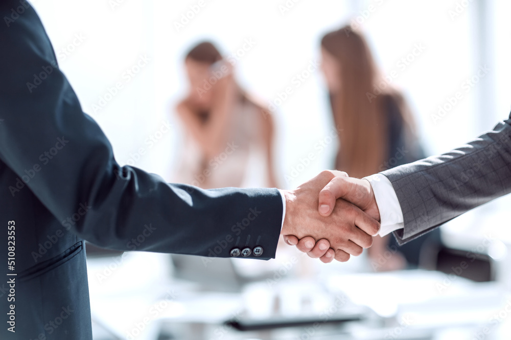 handshake of business people in the background of the office handshake of business people in the background of the office